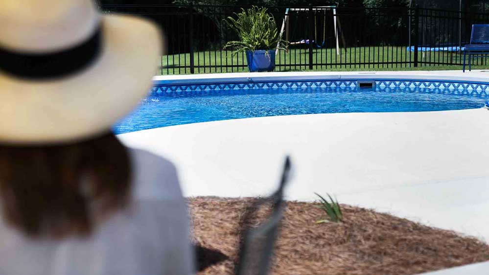 A backyard in Mississippi features a beautiful, serene pool created by Aqua + Oak.